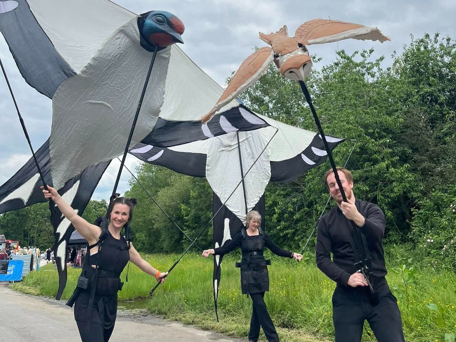 Three people puppeting birds